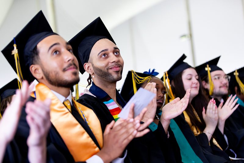 Students clapping at Commencement.